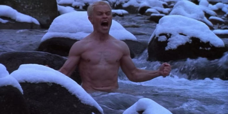 Private Reich standing waist-deep in a river screaming and surrounded by snow in Ravenous. 