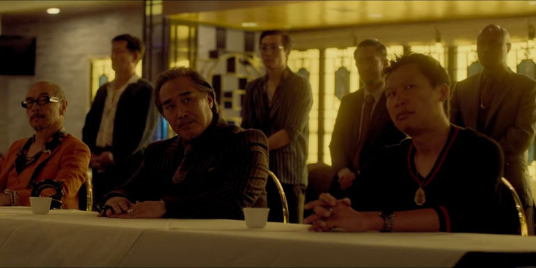 Triad Members and Leaders sitting at a table in The Brothers Sun 