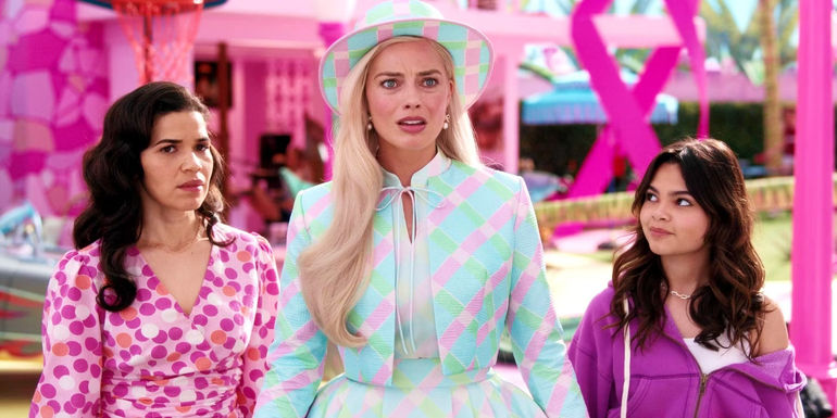 Barbie (Margot Robbie) looking confused while Gloria (America Ferrera) and Sasha (Ariana Greenblatt) stand next to her in Barbie.