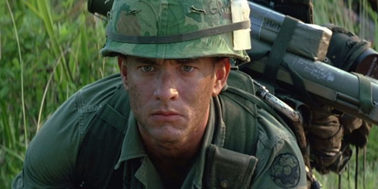 Forrest (Tom Hanks) in his soldier uniform, loaded down with gear in Vietnam in Forrest Gump.