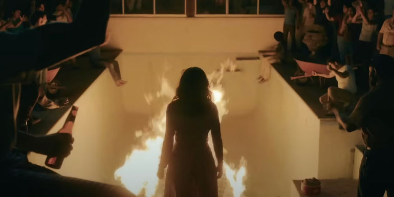 Sofía Vergara as Griselda is enthralled by a fire in a scene from Griselda.