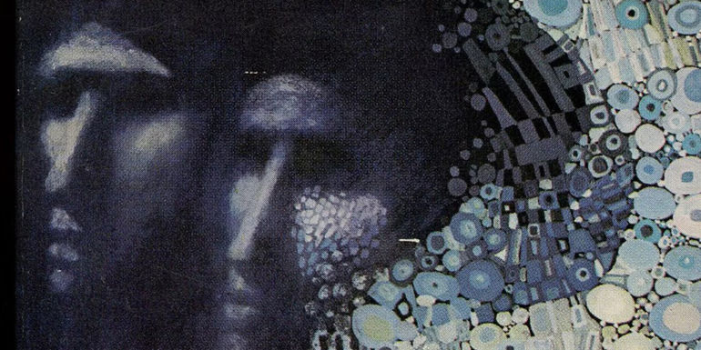 Cropped image of one of the many cover art pieces for the Ursula K. Le Guin book, The Left Hand of Darkness, showing two mysterious figures amid a stylized background in the style of artist Gustav Klimt.