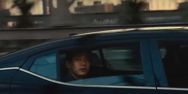 Hae Sung sitting in his taxi in Past Lives