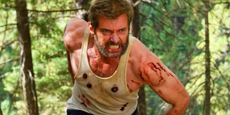 Hugh Jackman as Wolverine running in the woods in Logan