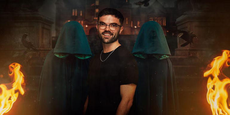 Ross from The Traitors UK Season 2 standing in front of two cloaked figures and a castle
