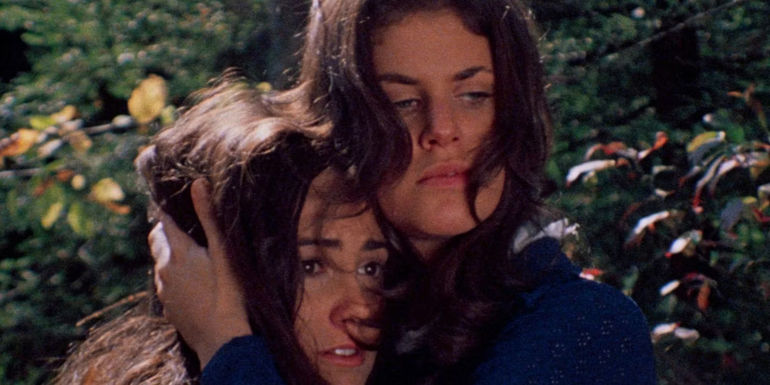 Sandra Peabody as Mari Collingwood and Lucy Grantham as Phyllis Stone hug each other in a frightful embrace in The Last House on the Left
