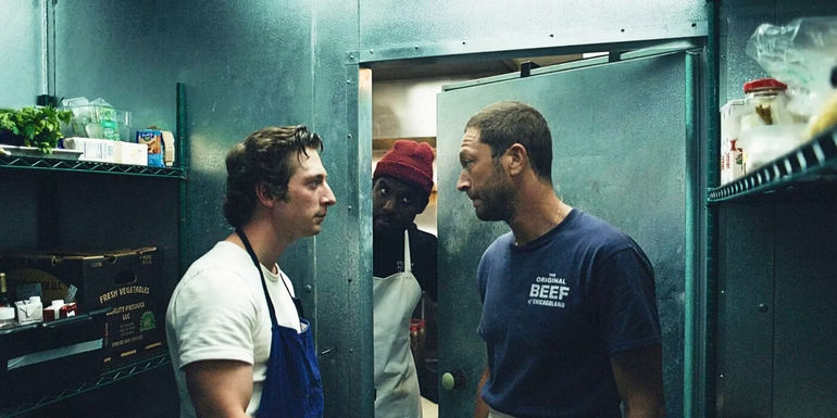 Carmy and Richie arguing in the freezer as Marcus peeks in in The Bear