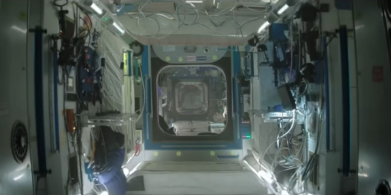 The camera looks down the hallways of the International Space Station replica in I.S.S.
