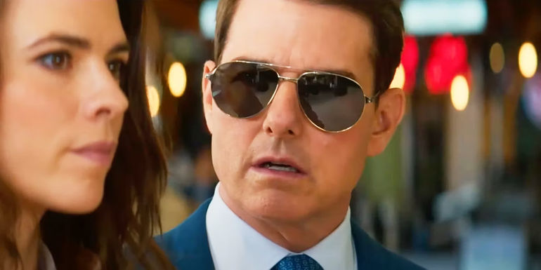 Tom Cruise wearing sunglasses and looking surprised as Ethan Hunt in Mission Impossible 7.