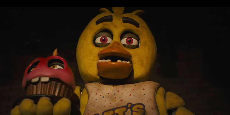 Chica from Five NIghts at Freddy's holding a cupcake animatronic