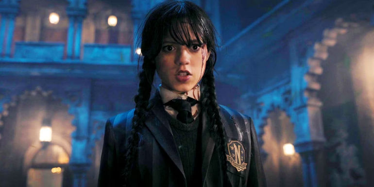 Jenna Ortega looks angry with blood dripping down the side of her face in Wednesday.