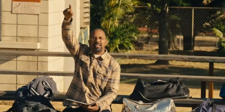 Mike Epps as Kareem holds the football playbook in The Underdoggs.