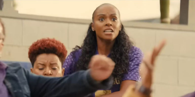 Tika Sumpter as Cherise cheers with other members of the crowd in The Underdoggs.