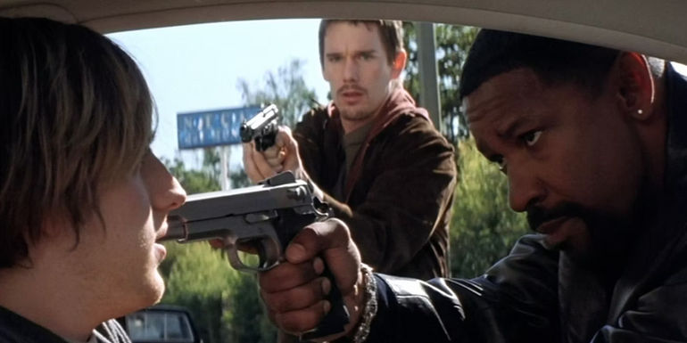 Denzel Washington as Det. Alonzo Harris (LAPD) and Ethan Hawke as Officer Jake Hoyt (LAPD) aim at a car passenger in Training Day.