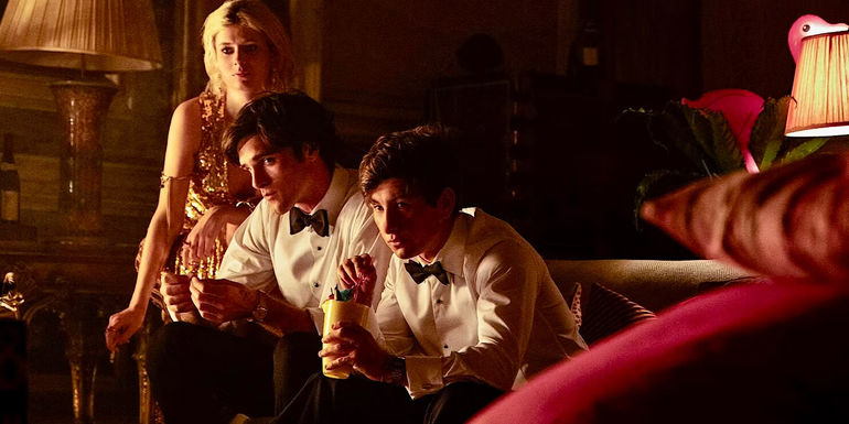 Oliver (Barry Keoghan), Felix (Jacob Elordi), and Venetia (Alison Oliver) dressed in fancy clothes looking offscreen in Saltburn.