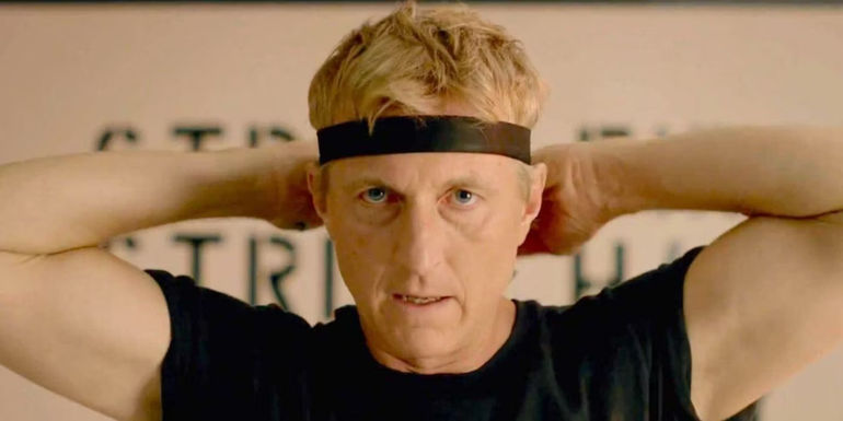 William Zabka as Johnny Lawrence tying a headband in Cobra Kai