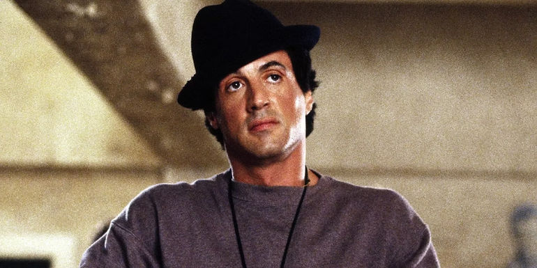 Sylverster Stallone wearing a hat is Rocky 5 while training