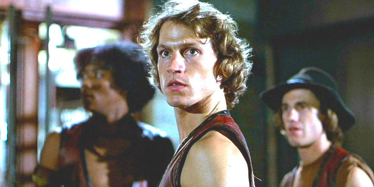 Three young men in 1970s clothing and hairstyles look ready to fight in the movie The Warriors