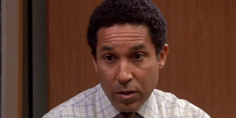 Oscar looking seriously at Michael in The office.