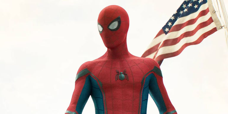 Tom Holland's Spider-Man stands in front of an American flag in Spider-Man: Homecoming
