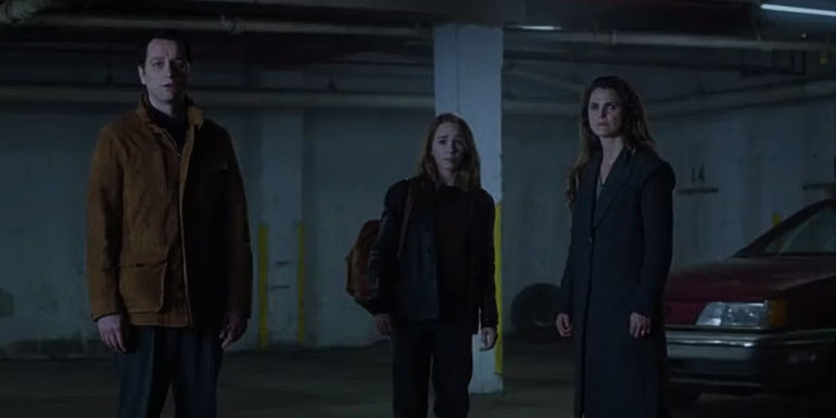 Matthew Rhys as Philip Jennings, Holly Taylor as Paige Jennings, and Keri Russell as Elizabeth Jennings standing in a dark parking garage in The Americans