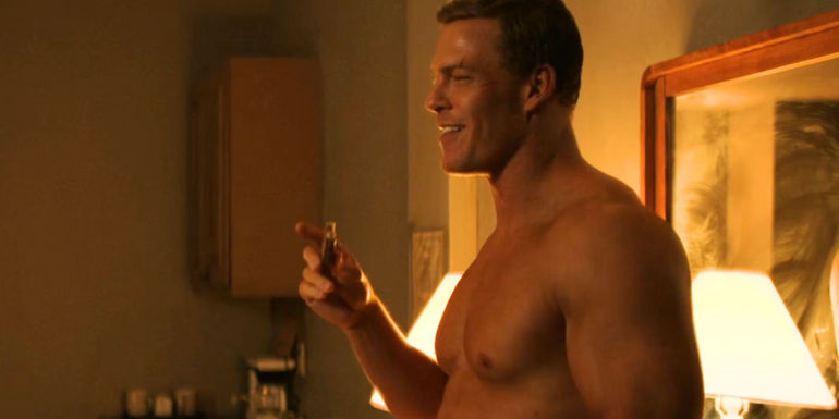 Alan Ritchson eating a Clark Bar as Reacher