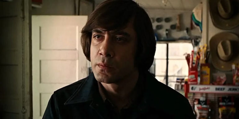Anton Chigurh (Javier Bardem) stares with intensity in No Country for Old Men.