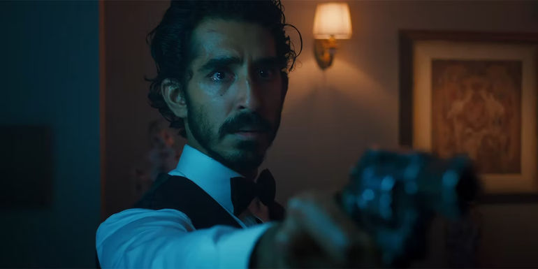 Dev Patel as Kid aiming gun in Monkey Man