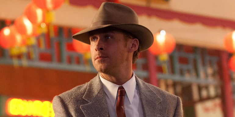 Sgt. Jerry Wooters (Ryan Gosling) wearing a fedora and suit in Gangster Squad.