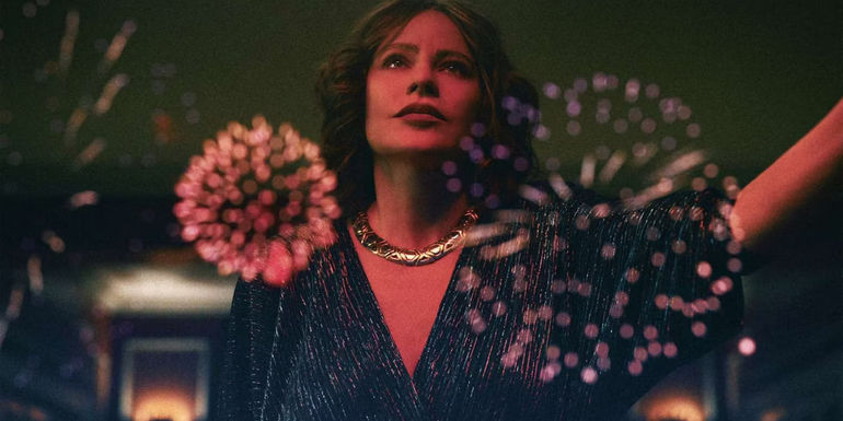 Sofia Vergara as Griselda watching fireworks through a window in Griselda