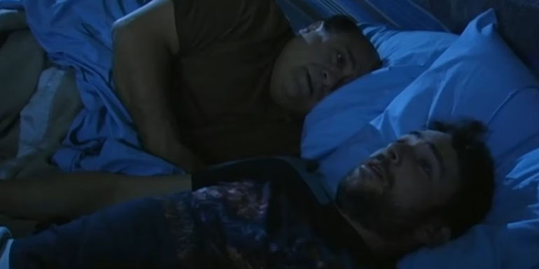 Frank (Danny DeVito) laying in bed next to Charlie (Charlie Day) in It's Always Sunny in Philadelphia The Gang Finds a Dumpster Baby..