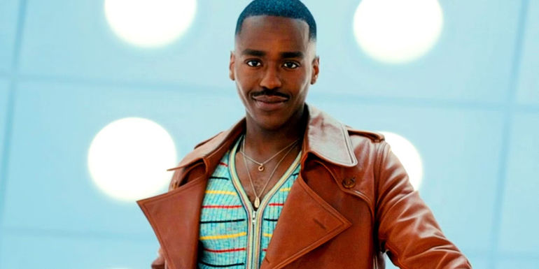 Ncuti Gatwa as the Doctor standing in the TARDIS wearing a brown coat