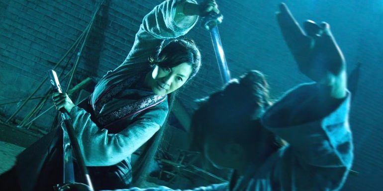 Michelle Yeoh holding up a sword
