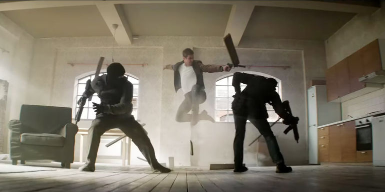 Sam Rockwell jumping in the air and shooting someone in Argylle.