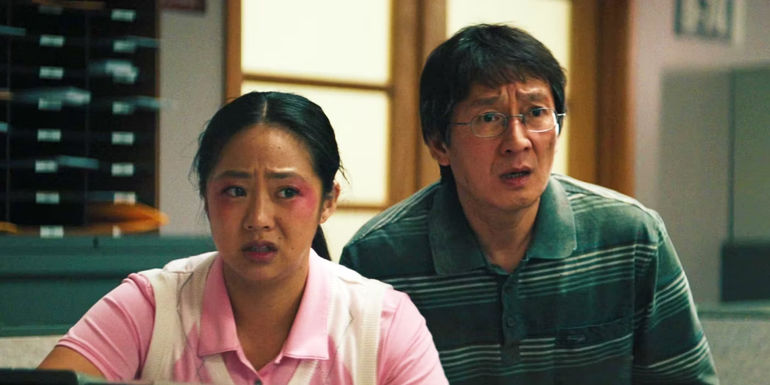 Stephanie Hsu as Joy and Ke Huy Quan as Waymond look shocked in Everything Everywhere All At Once.