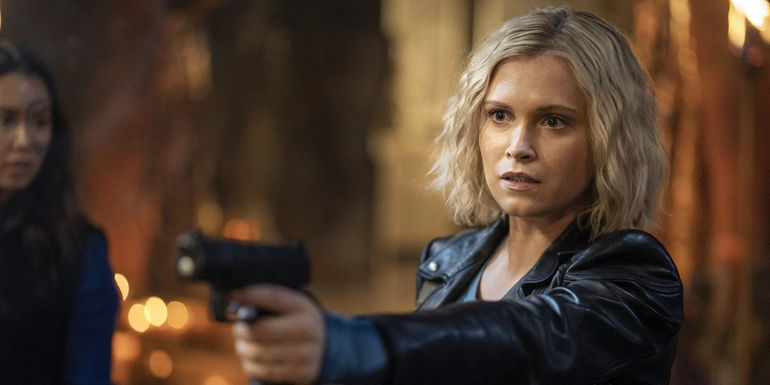 Clarke holds a gun on Bellamy in The 100