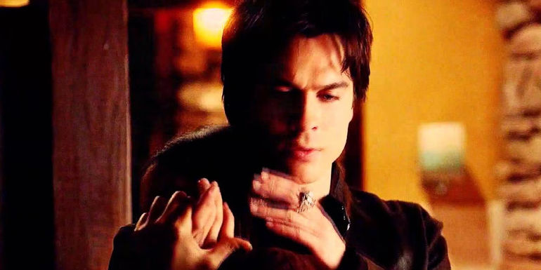 Damon cradling Elenas head while she drinks from his wrist in The Vampire Diaries episode Memorial