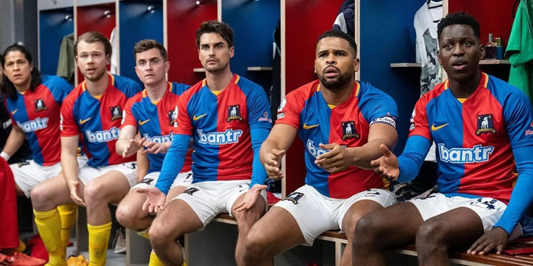 AFC Richmond players sitting in the locker room, looking distraught Ted Lasso