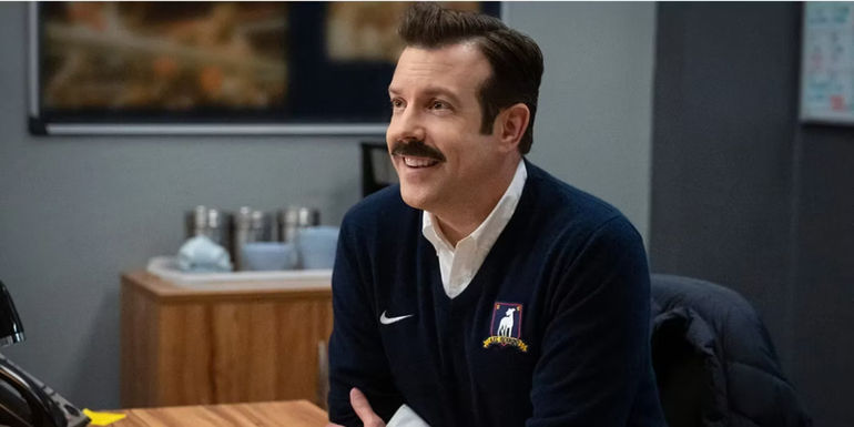 Ted Lasso (Jason Sudeikis) behind his desk in Ted Lasso