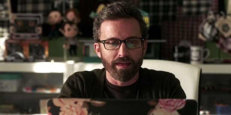 Rob Benedict As Chuck Writing Something on His Computer In Supernatural Season 15
