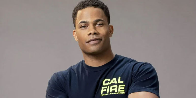 Jake Crawford (Jordan Calloway) smiling with his arms crossed in Fire Country.