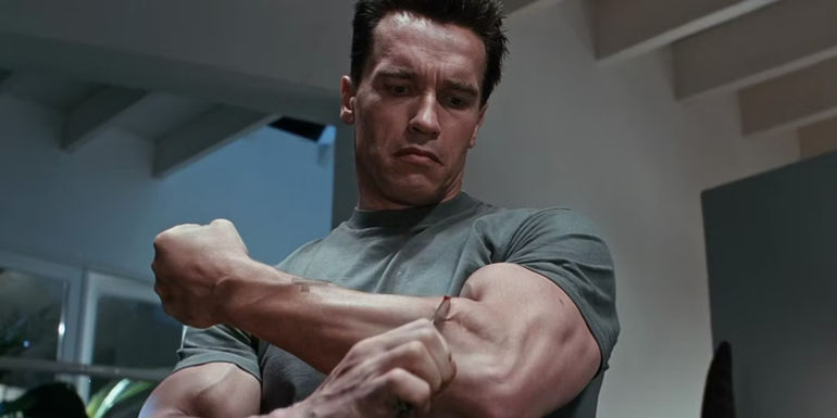 The Terminator (Arnold Schwarzenegger) cutting himself with a knife in Terminator 2 Judgment Day