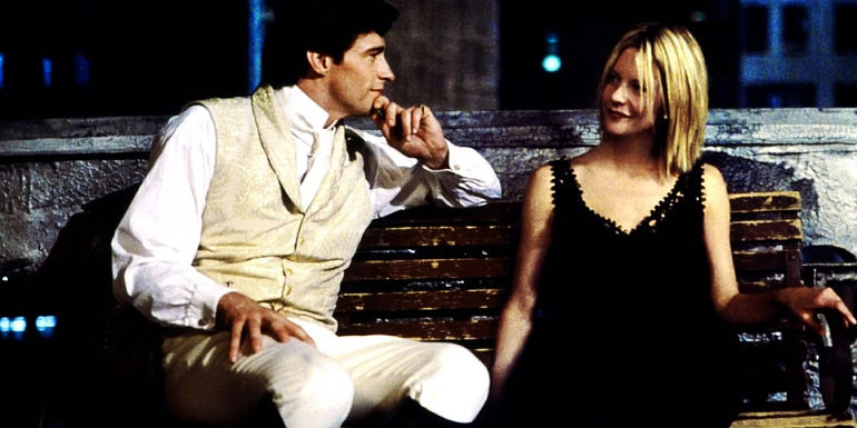 Hugh Jackman and Meg Ryan sitting on a bench in Kate & Leopold