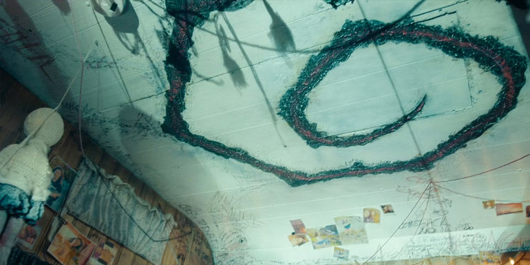 Large black and red Spiral on Ceiling in True Detective Night Country