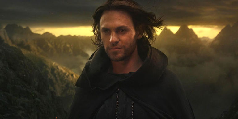 Charlie Vickers as Halbrand smiling in Mordor in The Lord of the Rings The Rings of Power Season 1 Episode 8
