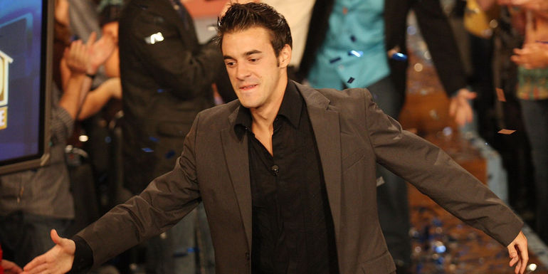 Dan Gheesling reaching out to give someone a handshake in Big Brother.