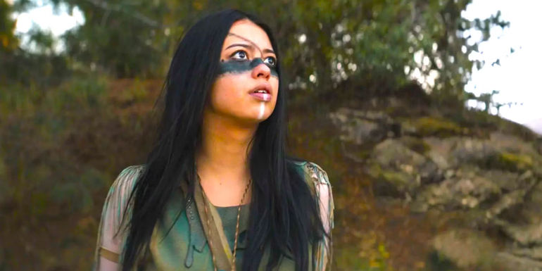 Amber Midthunder looking up at the sky with trepidation in Prey