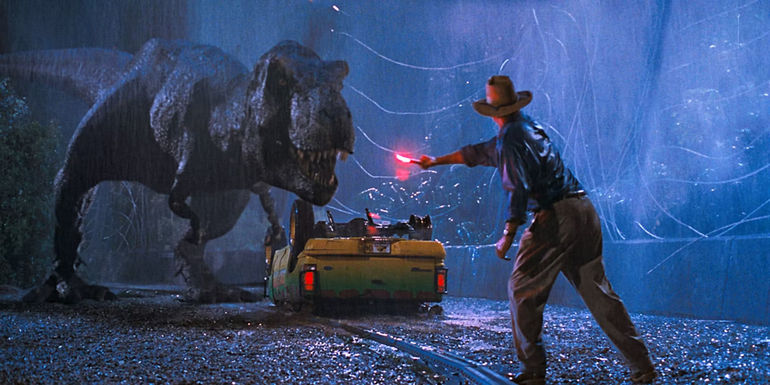 Sam Neill's Alan Grant distracts the T-Rex in front of a flipped jeep in Jurassic Park