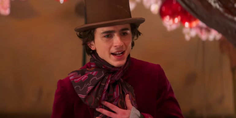 Timothee Chalamet as Willy holding his hand to his chest in Wonka
