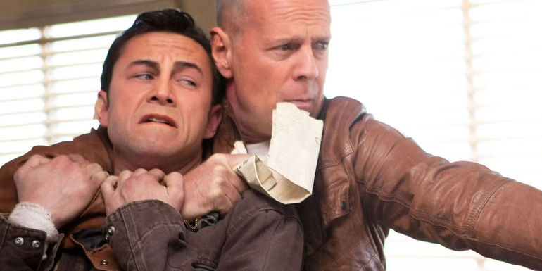 Bruce Willis as Joe holding Joseph Gordon-Levitt as a younger Joe hostage in Looper